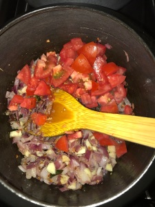 Now add the chopped tomatoes and saute for a minute.